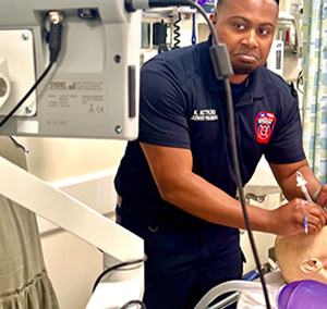 A medic checks a monitor