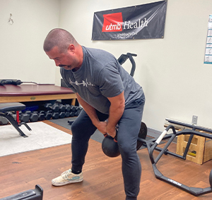 image of male pulling a kettlebell back