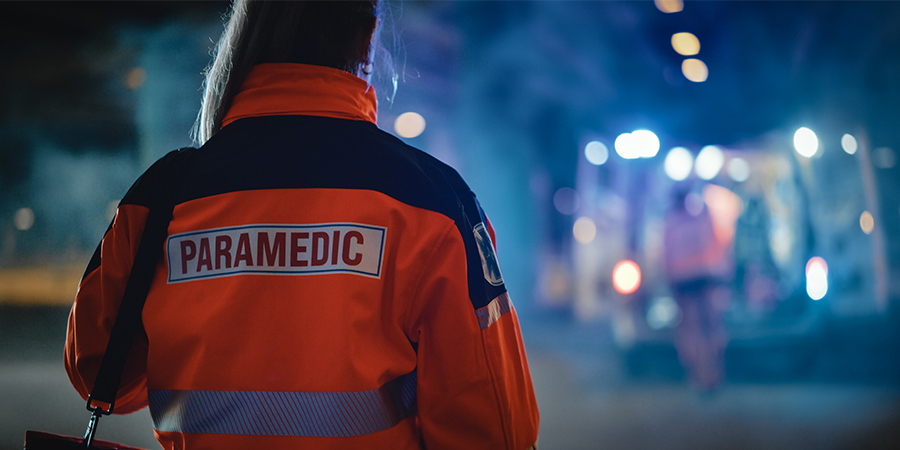 Image of the back of a paramedic wearing a jacket with the word "paramedic" on it