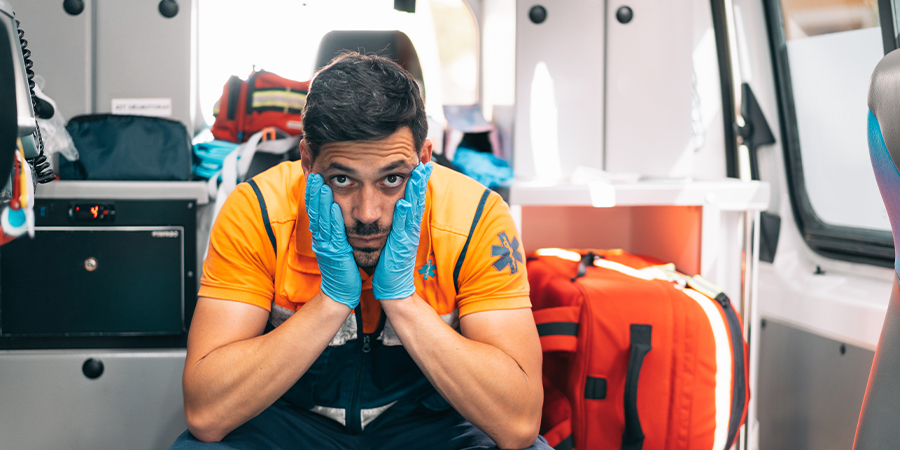 Stressed medic sits in ambulance