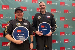 UTMB EMS members posing for photo  placards