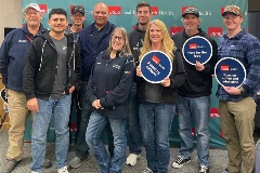 UTMB EMS members posing for photo, some people holding placards