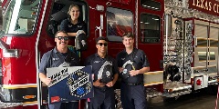 four first responders in front of a mobile response vehicle
