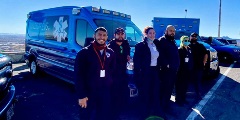 Individuals standing in front of Windsor EMS vehicles.
