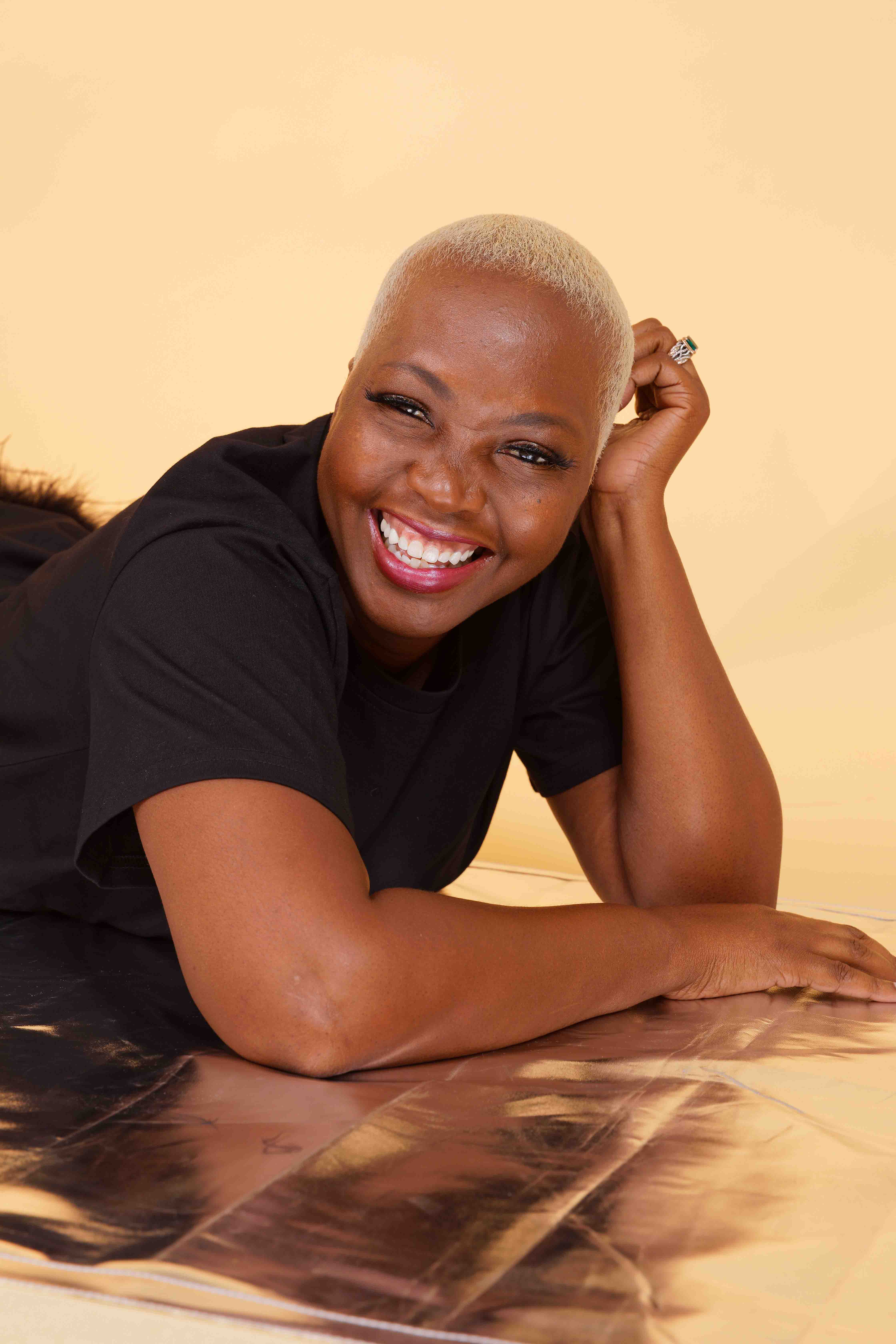 image of Breast Cancer survivor Katina Herring - proudly smiling in black shirt 