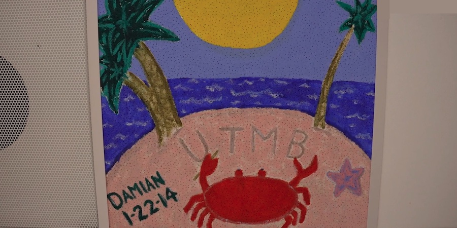 Hand-painted ceiling tile featuring a beach scene with palm trees, ocean waves, a sun and a red crab, displayed on the ceiling of a pediatric hospital unit as part of a patient art program