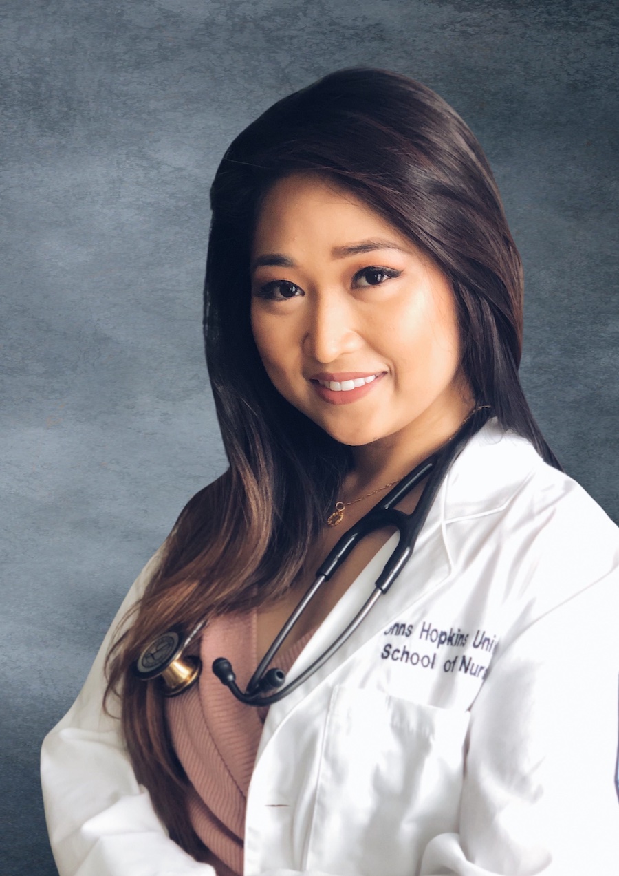female clinician in white coat with stethoscope