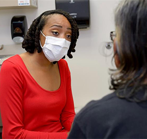 Dr. Elisha Jackson consulting a patient