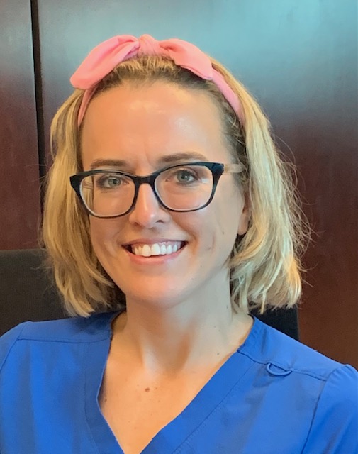 close-up, headshot image of physical therapist assistant Hannah Gardner. She has blonde, chin-length hair and is wearing dark-rimmed glasses and a pink headband