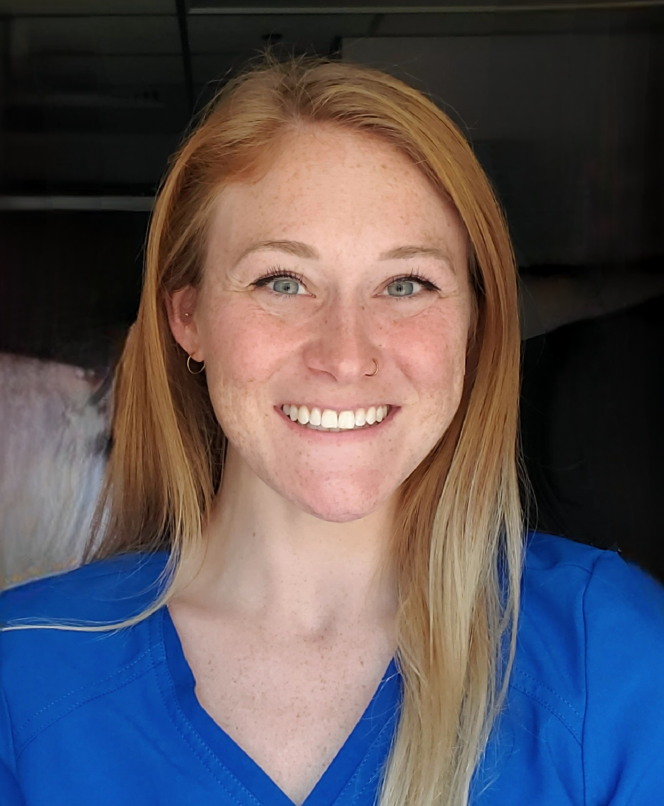 close-up headshot image of senior physical therapist kaitlyn lozano wearing a blue scrub top