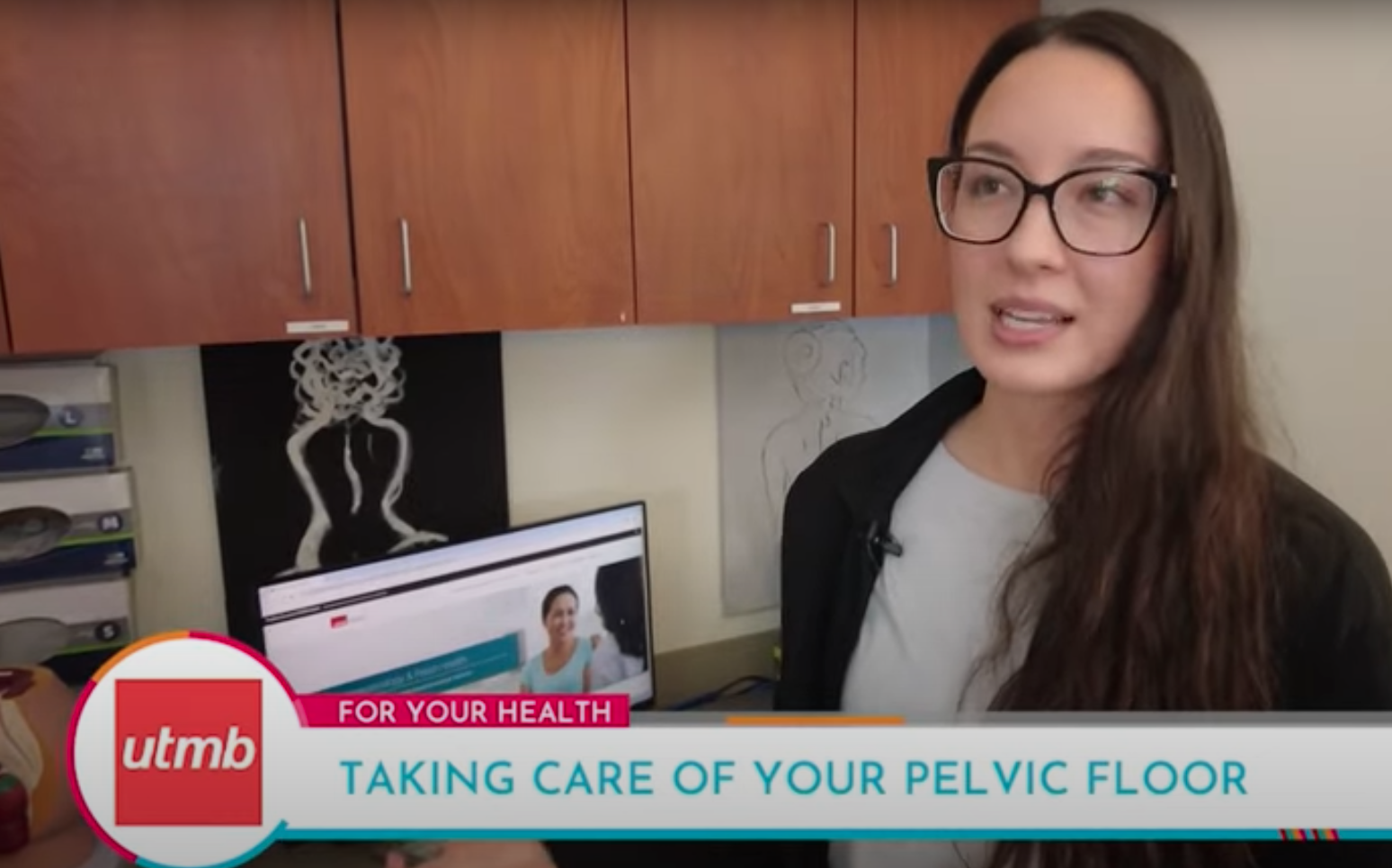 screen capture of a caucasian female wearing glasses positioned on the right side of the screen. there's a computer to her right and a footer that reads