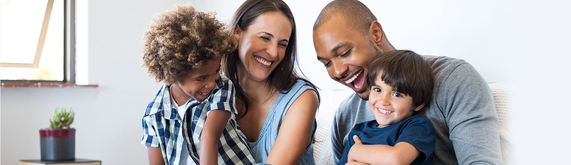 A family of four laughing together