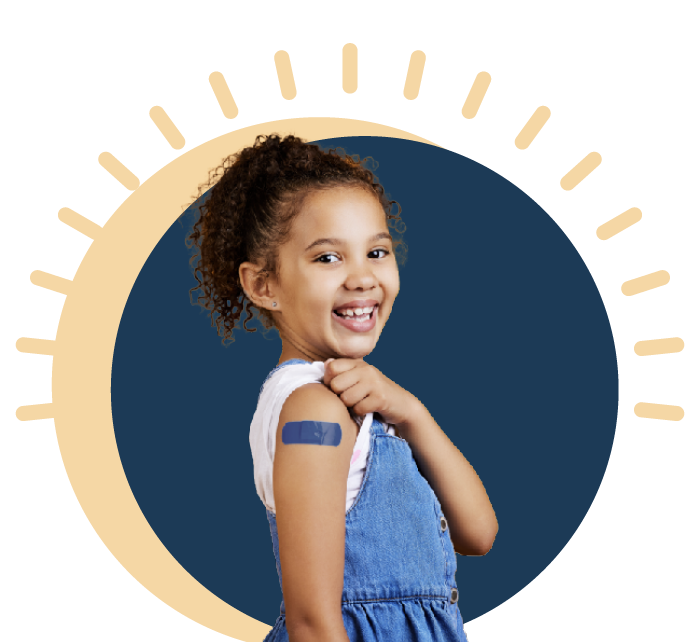 young girl smiling with a bandaid on his shoulder
