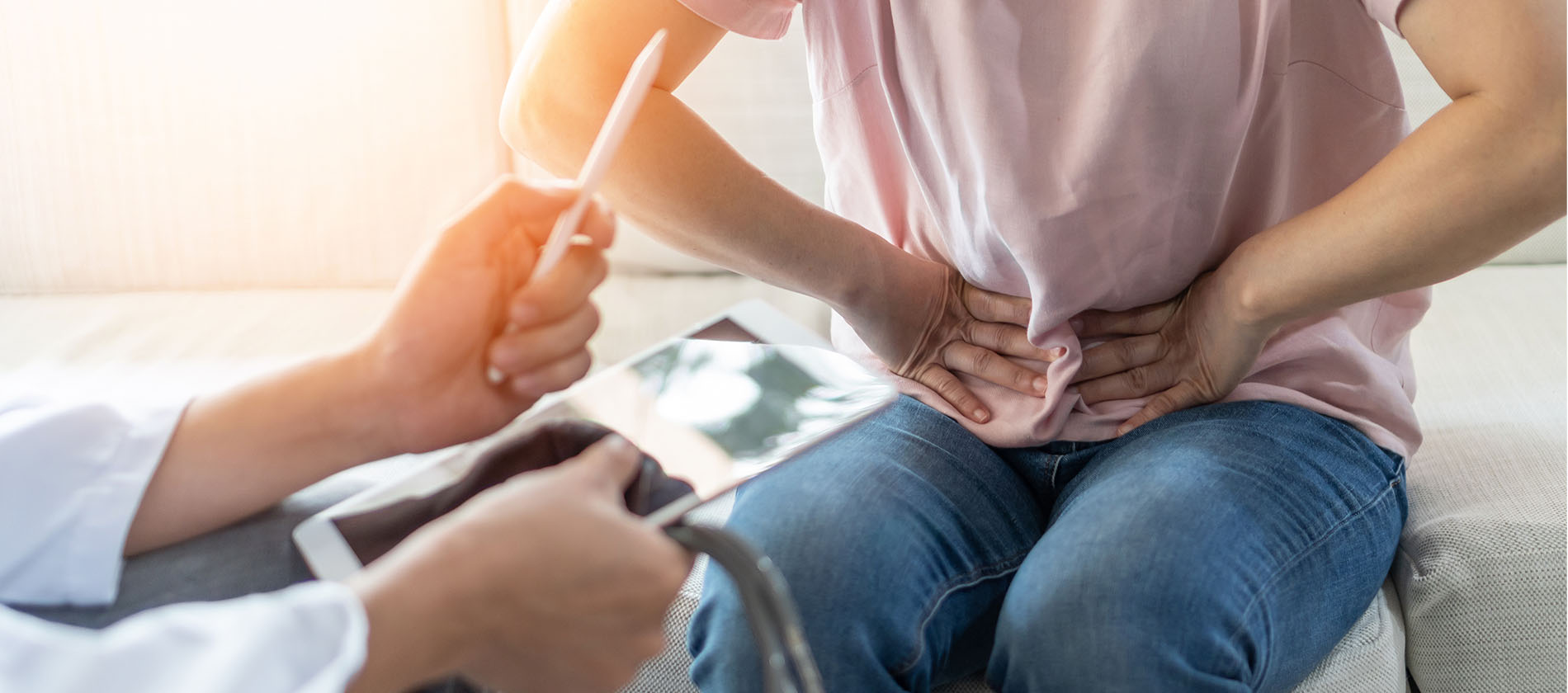 Person holding stomach in pain