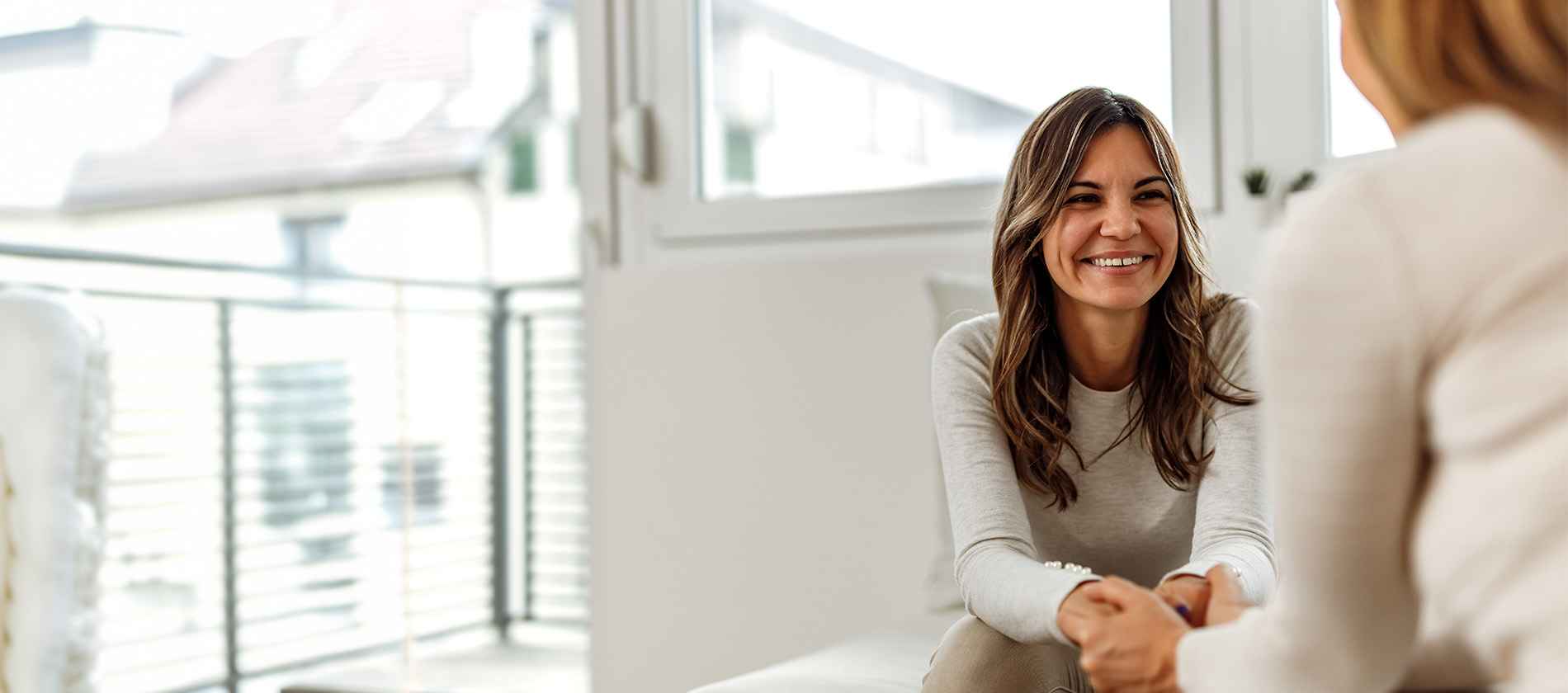 A smiling woman in a therapy session representing compassionate adult behavioral and mental health care at UTMB.