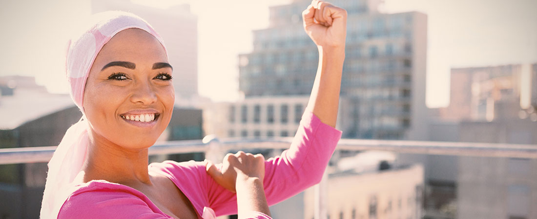 Breast cancer patient wearing pink in front of skyline