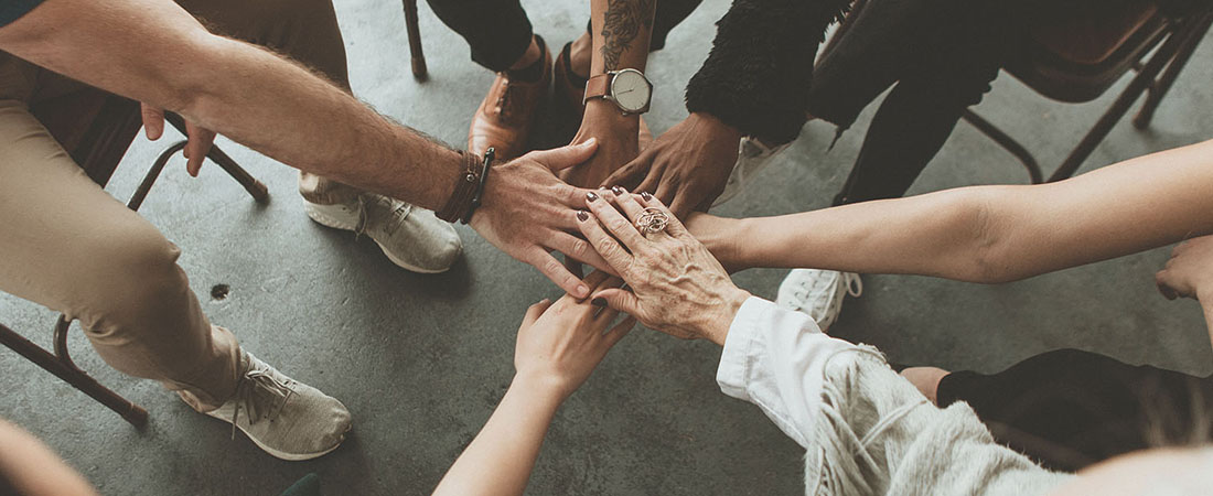 Group of people with hands together