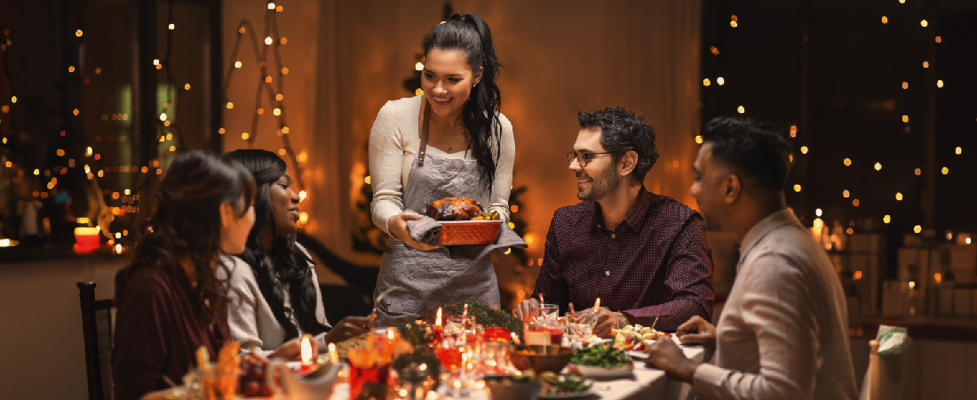 A group of young adults gathering at a table enjoying a meal