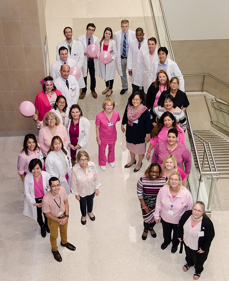 Group of people forming Cancer ribbon