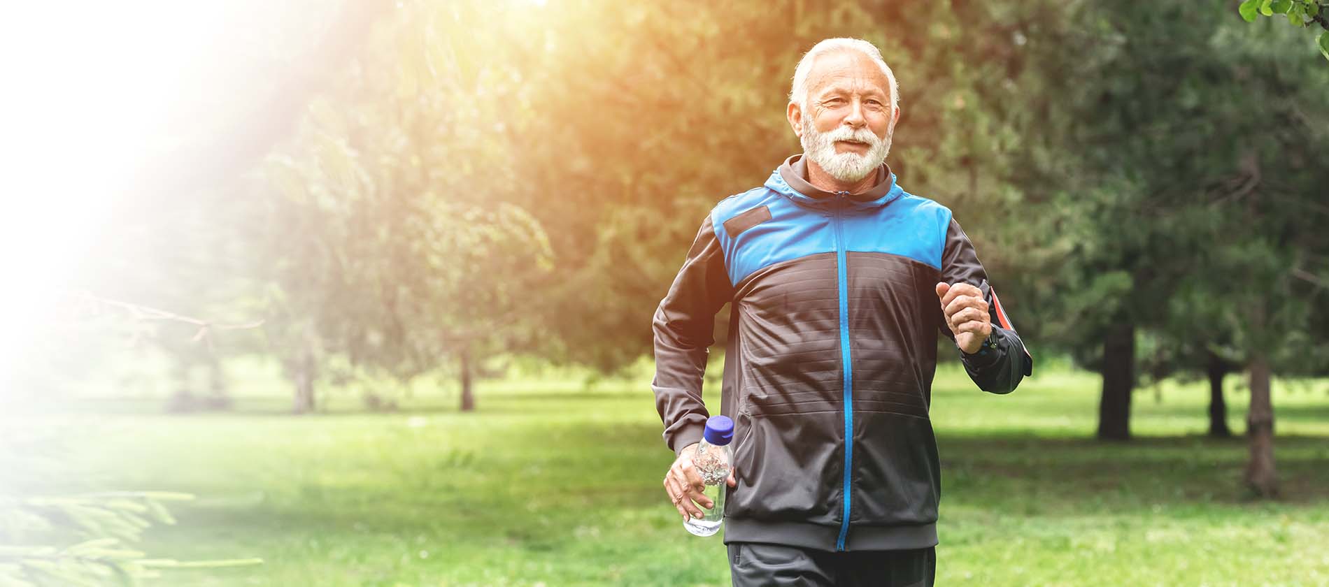 older man jogging at park