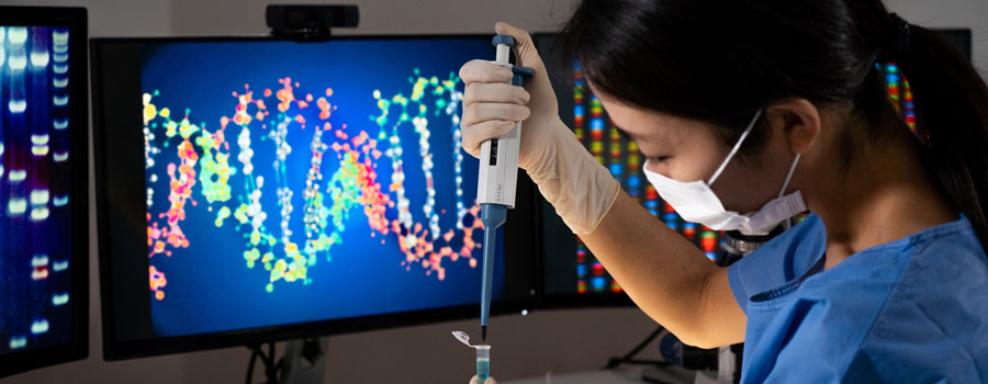 A laboratory scientist analyzes DNA sequencing data while performing genetic testing research at UTMB Health.
