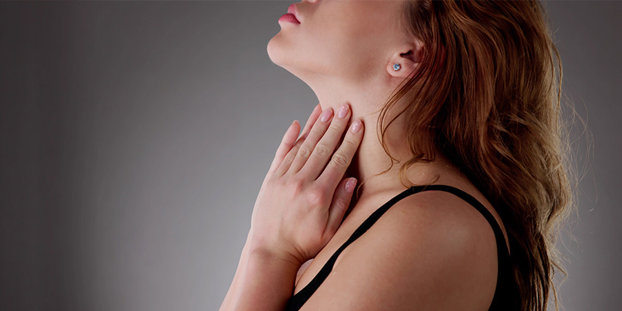Woman grasping neck in pain