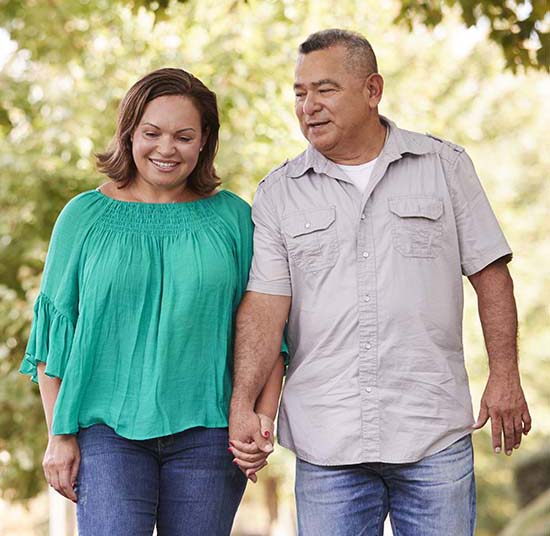 husband and wife walking in the park