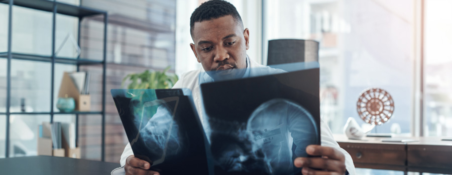 Neurodiagnostics physician reviewing diagnostic imaging to evaluate neurological conditions.