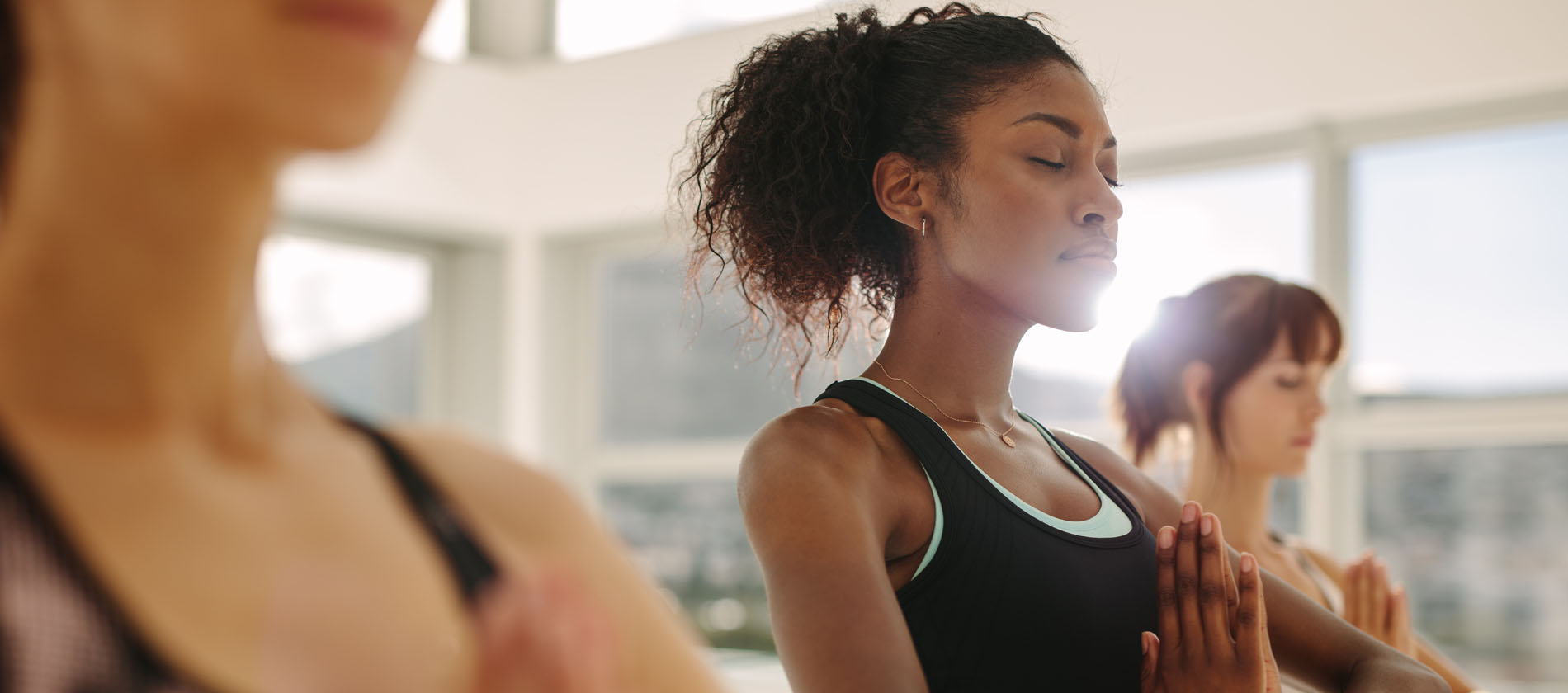 Individuals practice yoga to support stress management and wellness for epilepsy care.