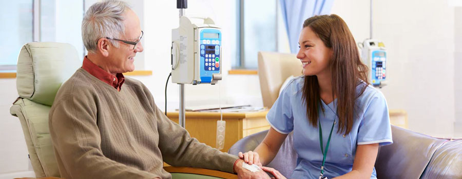 A patient receives infusion therapy while a nurse provides support during immunotherapy treatment for neurologic conditions.