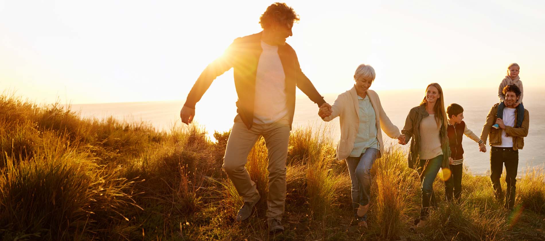 A group of people walk together outdoors representing connection independence and quality of life while living with neuroimmunologic conditions.