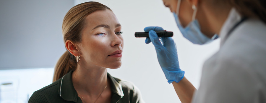 A clinician checks pupil response during a neurological exam for epilepsy at UTMB Health