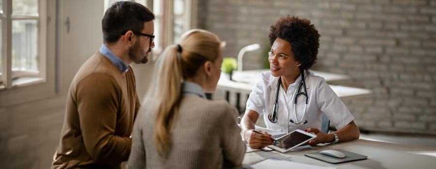 A neurosurgery provider discusses care options with adult patients during a hydrocephalus and Chiari malformation consultation at UTMB Health.