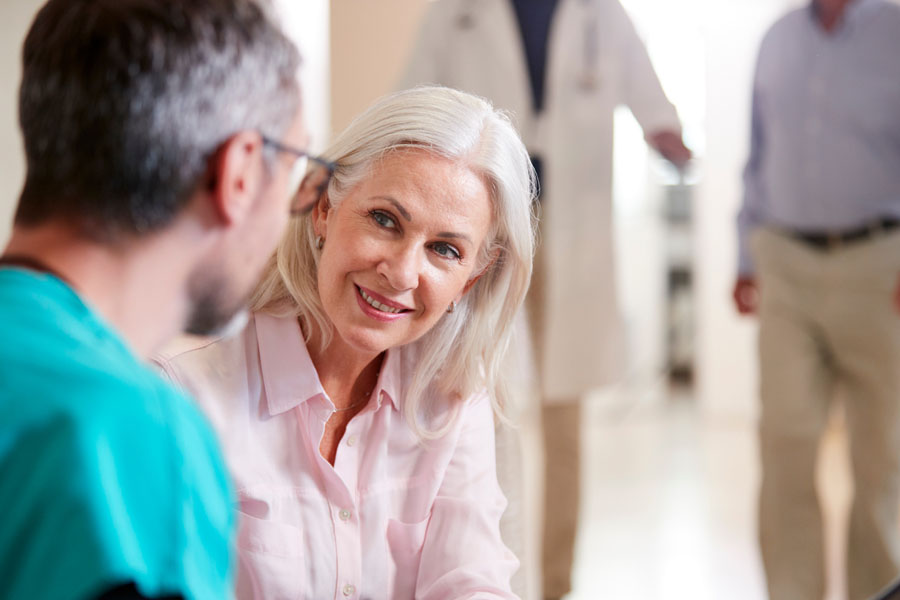 A neurosurgery provider listens as a patient discusses long term pain symptoms during a chronic pain consultation at UTMB Health.