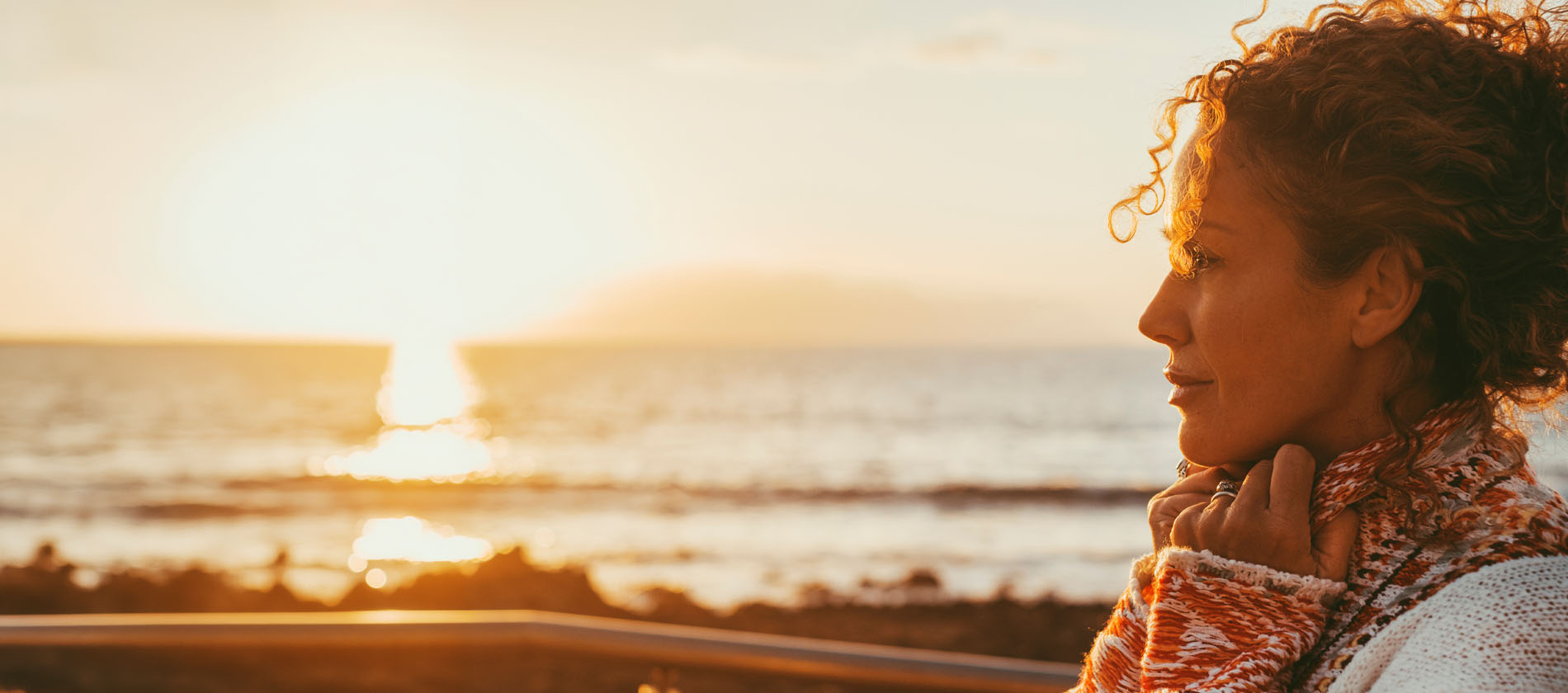 An adult woman looks calm outdoors, reflecting relief and improved quality of life after facial pain treatment.