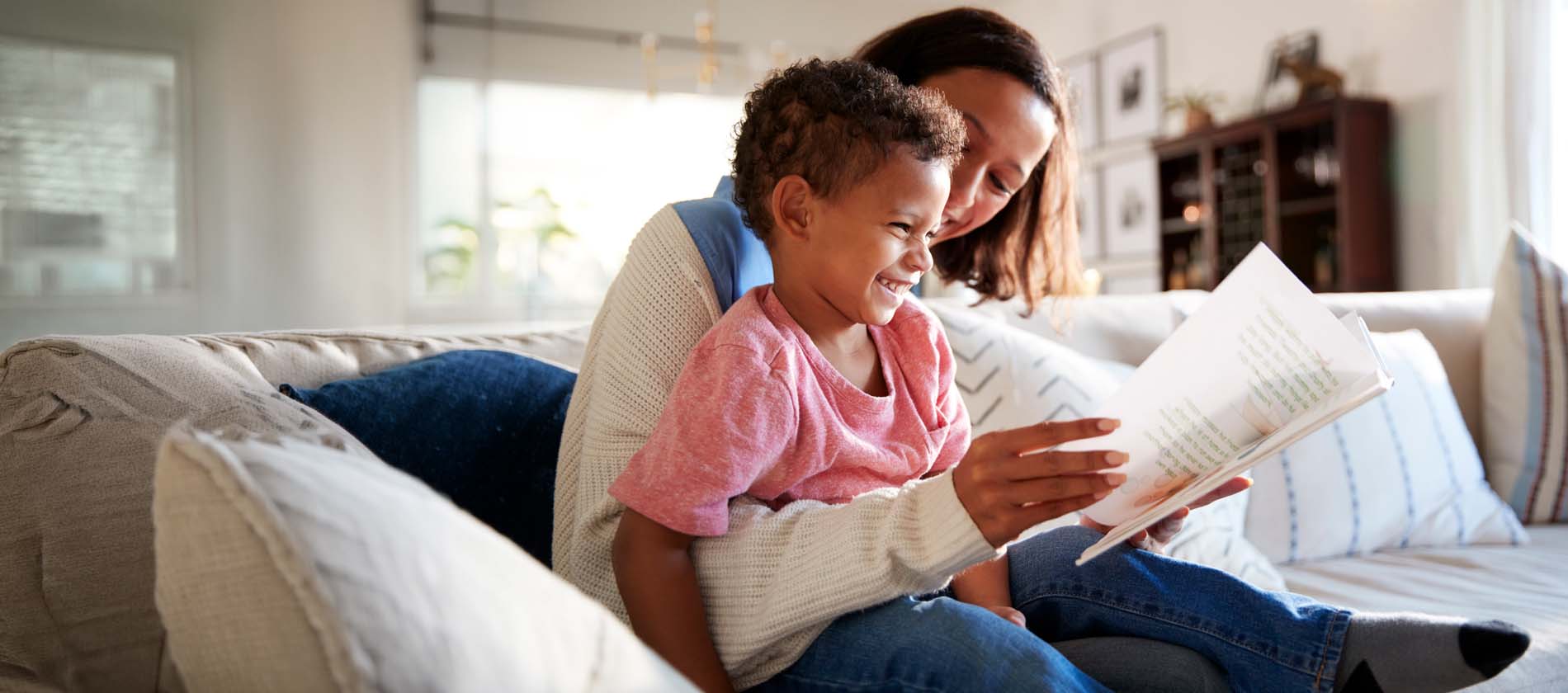 A parent and child read together at home, reflecting comfort, recovery, and quality of life after pediatric neurosurgery care.