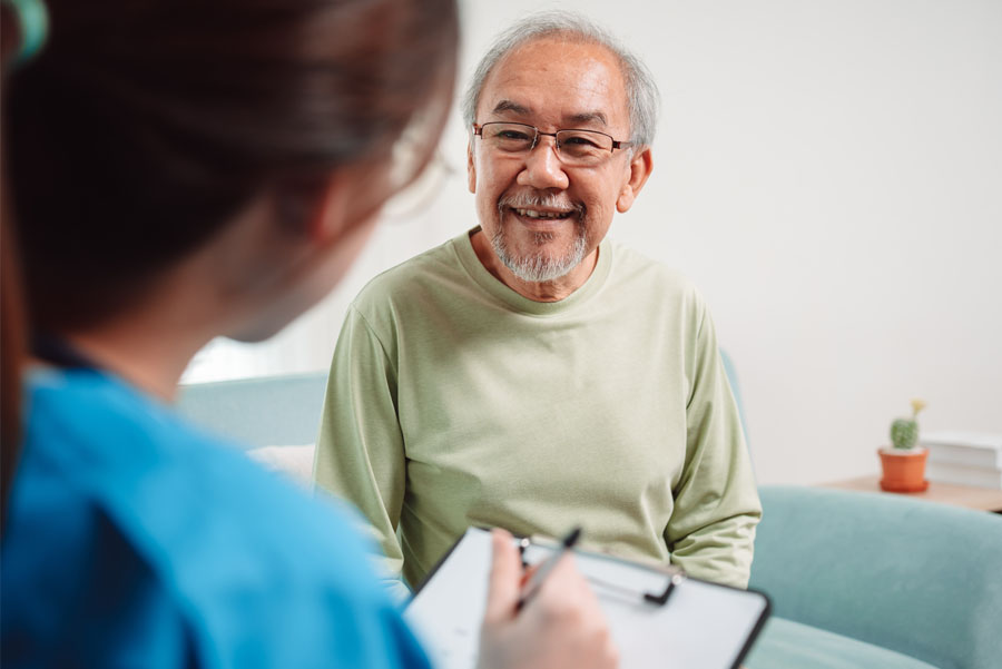 A neurosurgery provider listens as an older adult discusses symptoms during a stroke and neurovascular evaluation at UTMB Health.