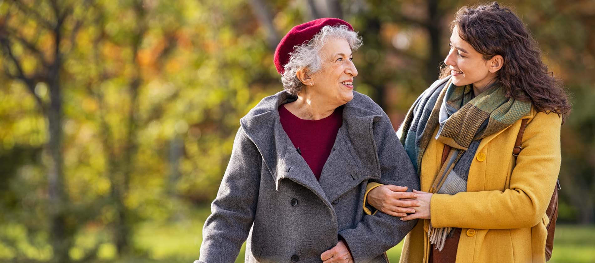 An older adult walks outdoors with support, reflecting recovery, balance, and quality of life after stroke care at UTMB Health. 