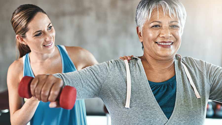 Middle aged woman lifting weights