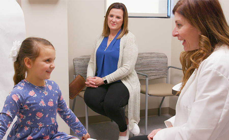 Doctor, mom and daughter interacting