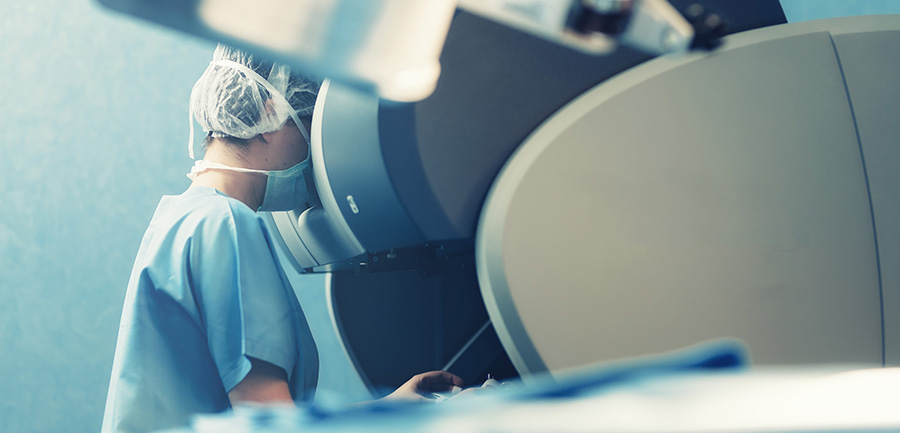 Doctor in scrubs looking in a medical machine