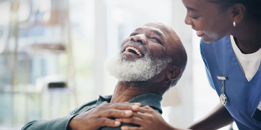 Elderly man, caregiver and holding hands for comfort with wheelchair, rehabilitation support and empathy. Volunteer, help and patient with disability for healthcare service, medical advice and house