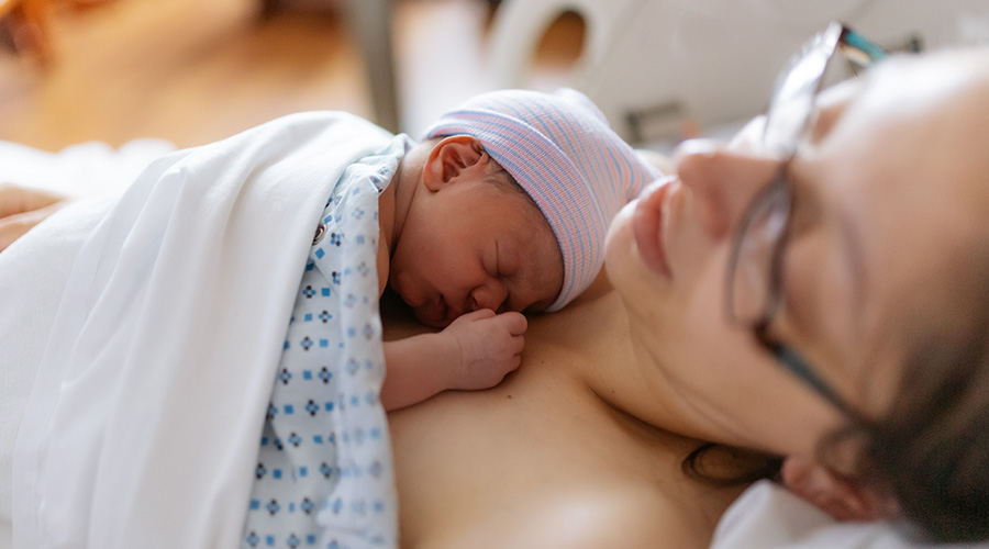 A newborn baby rests skin to skin on a parent shortly after birth at UTMB Health Labor and Delivery in Galveston.