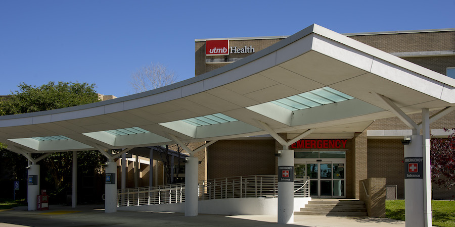 image of building exterior. The words UTMB Health and EMERGENCY are visible.