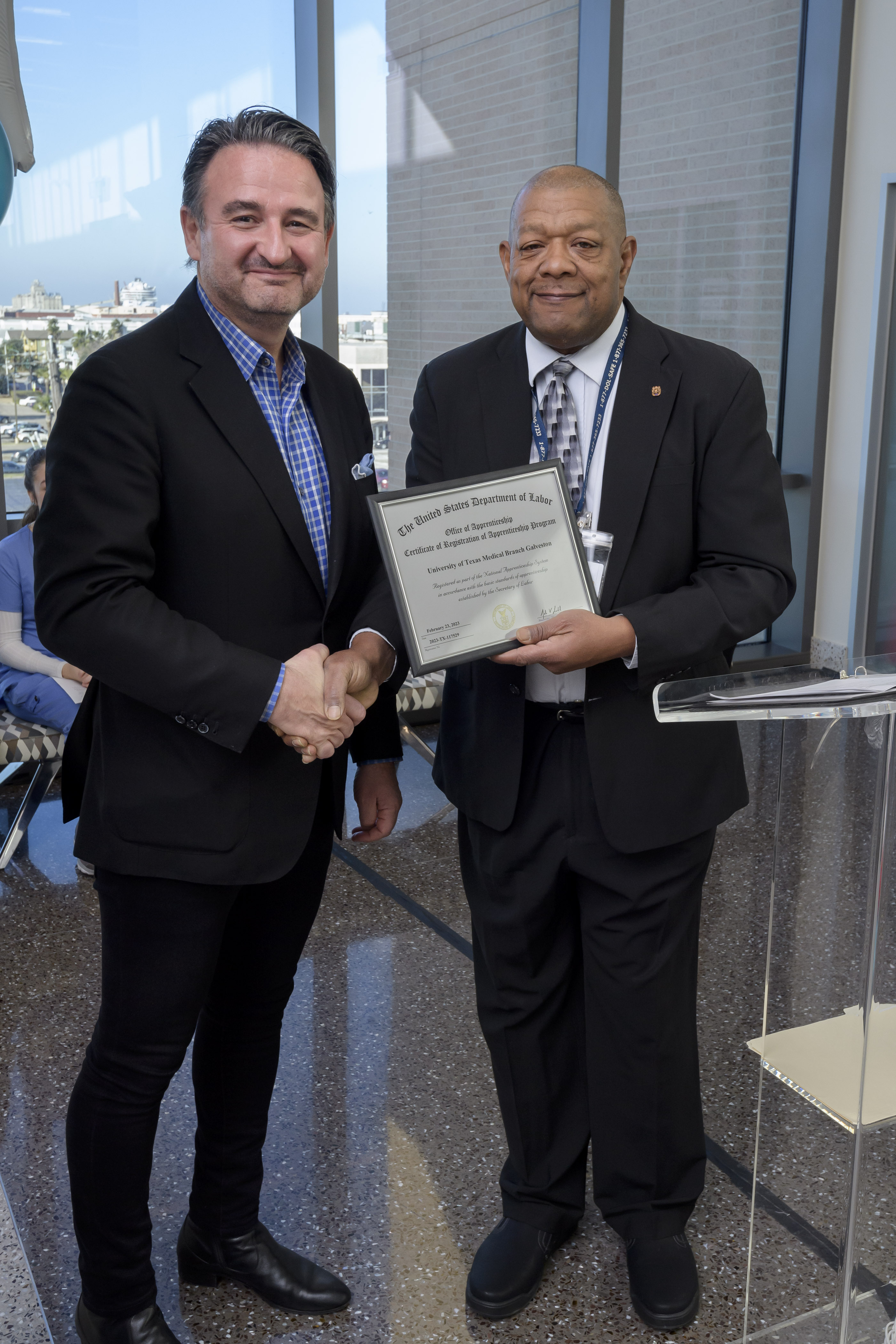 Dr. Reiser, president of UTMB, shaking hands and recieving a certificate
