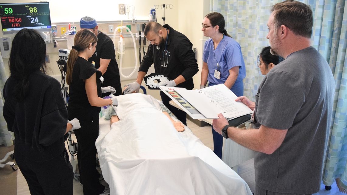 UTMB Disaster Day participants work with a mannequin during an emergency simulation.