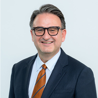 Jochen Reiser in a blue business suit. 