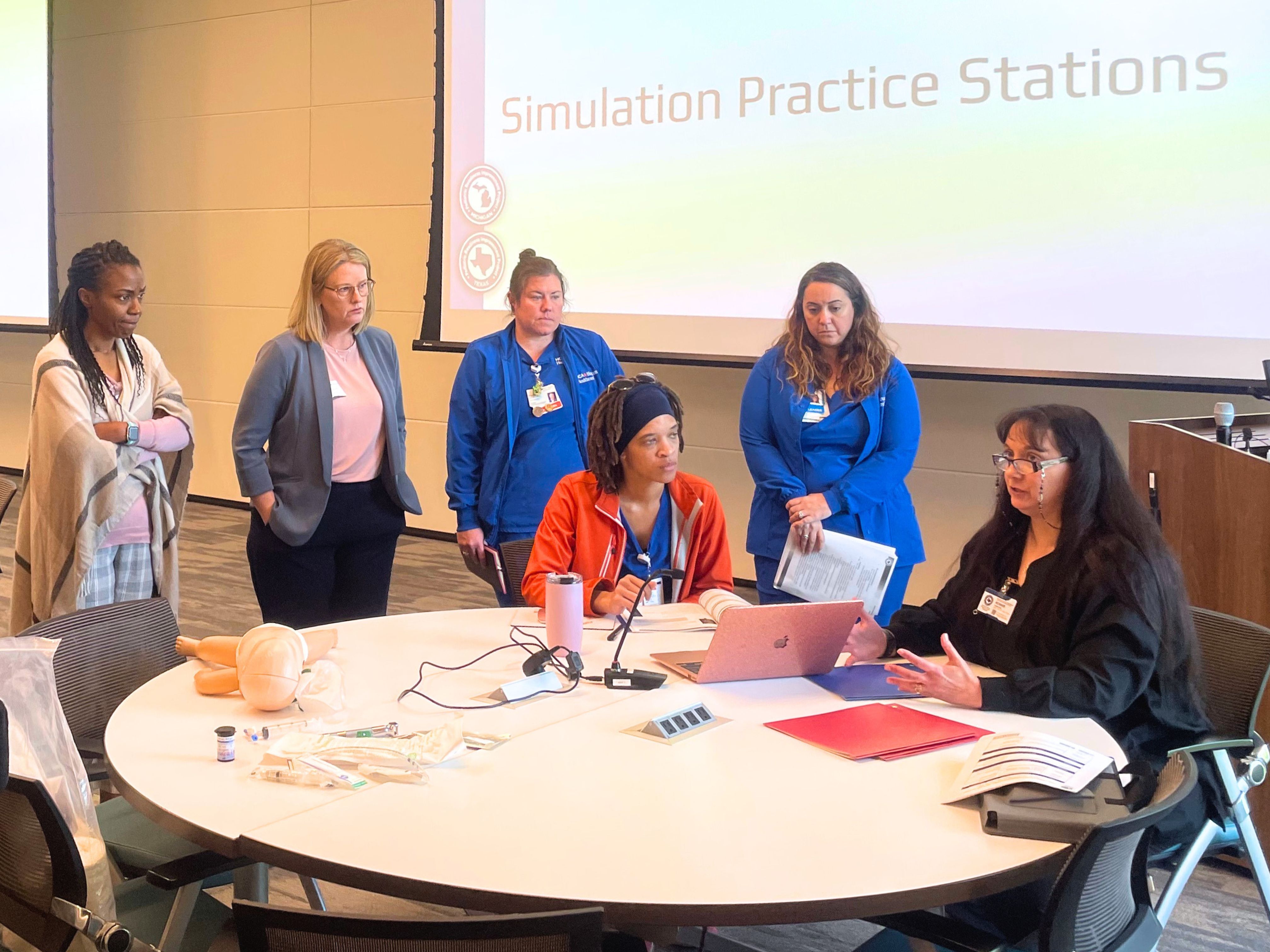 A group of health care providers sit around a table 