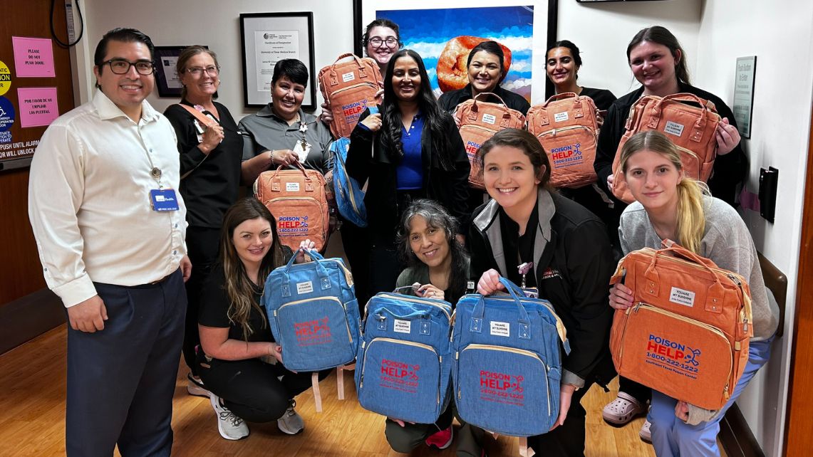 Members of the Poison Control Center pose with the baby kits they assembled
