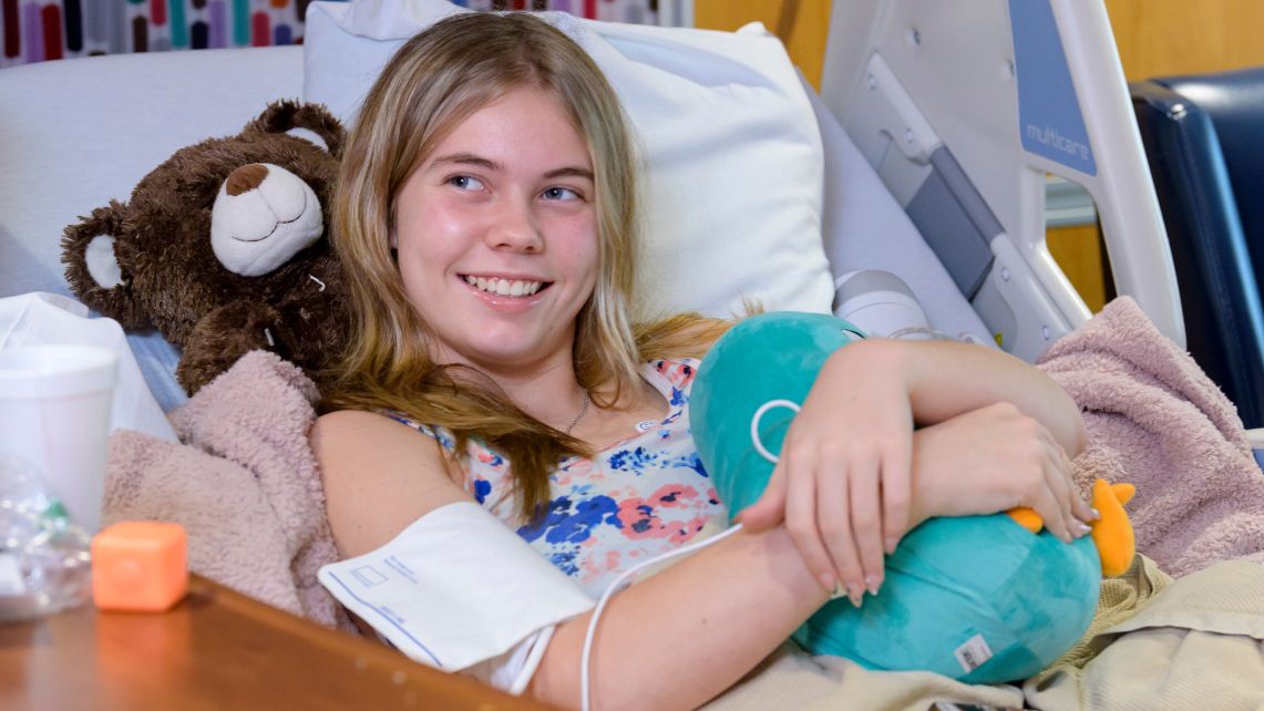 A patient at UTMB John Sealy Hospital hugs a stuffed toy donated by Tantrum Merch and Starlight Children's Foundation